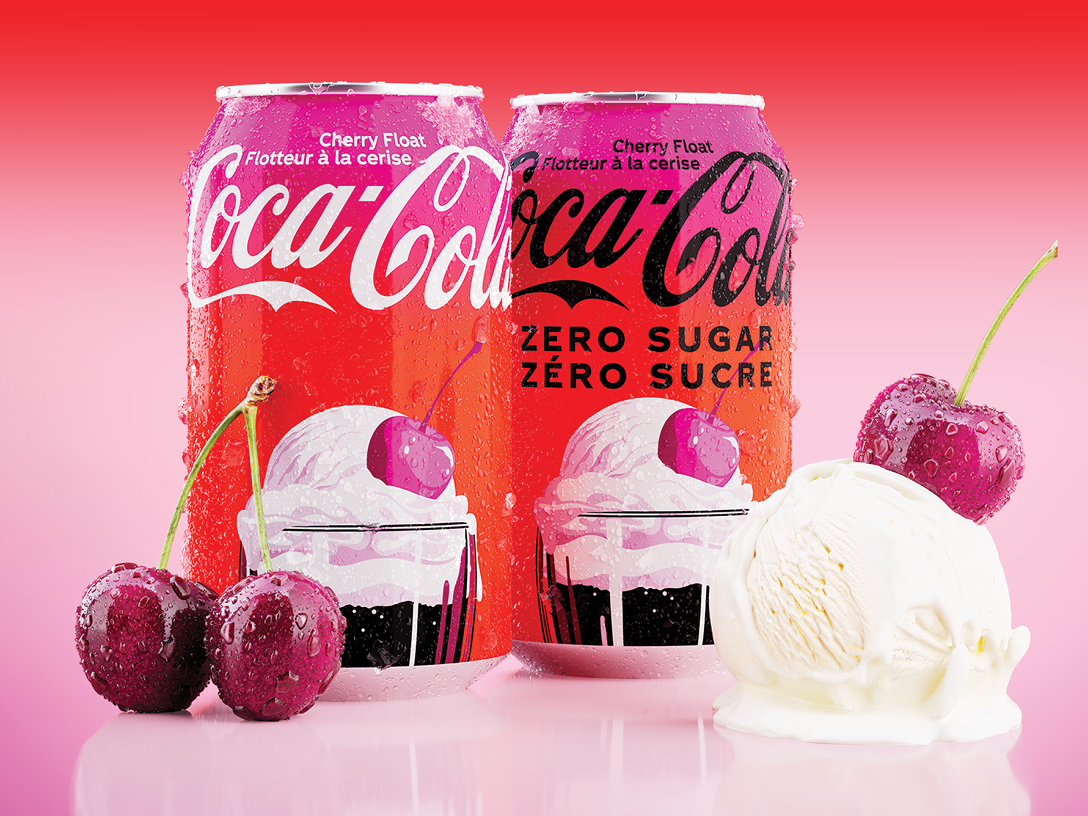 Two Cherry-flavoured Coca-Cola cans with cherries and ice cream.