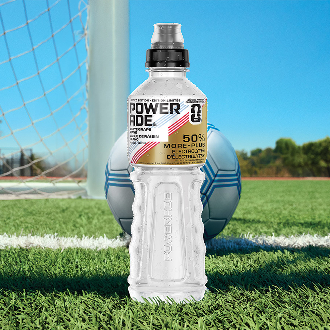 a bottle of white grape wave on a soccer field
