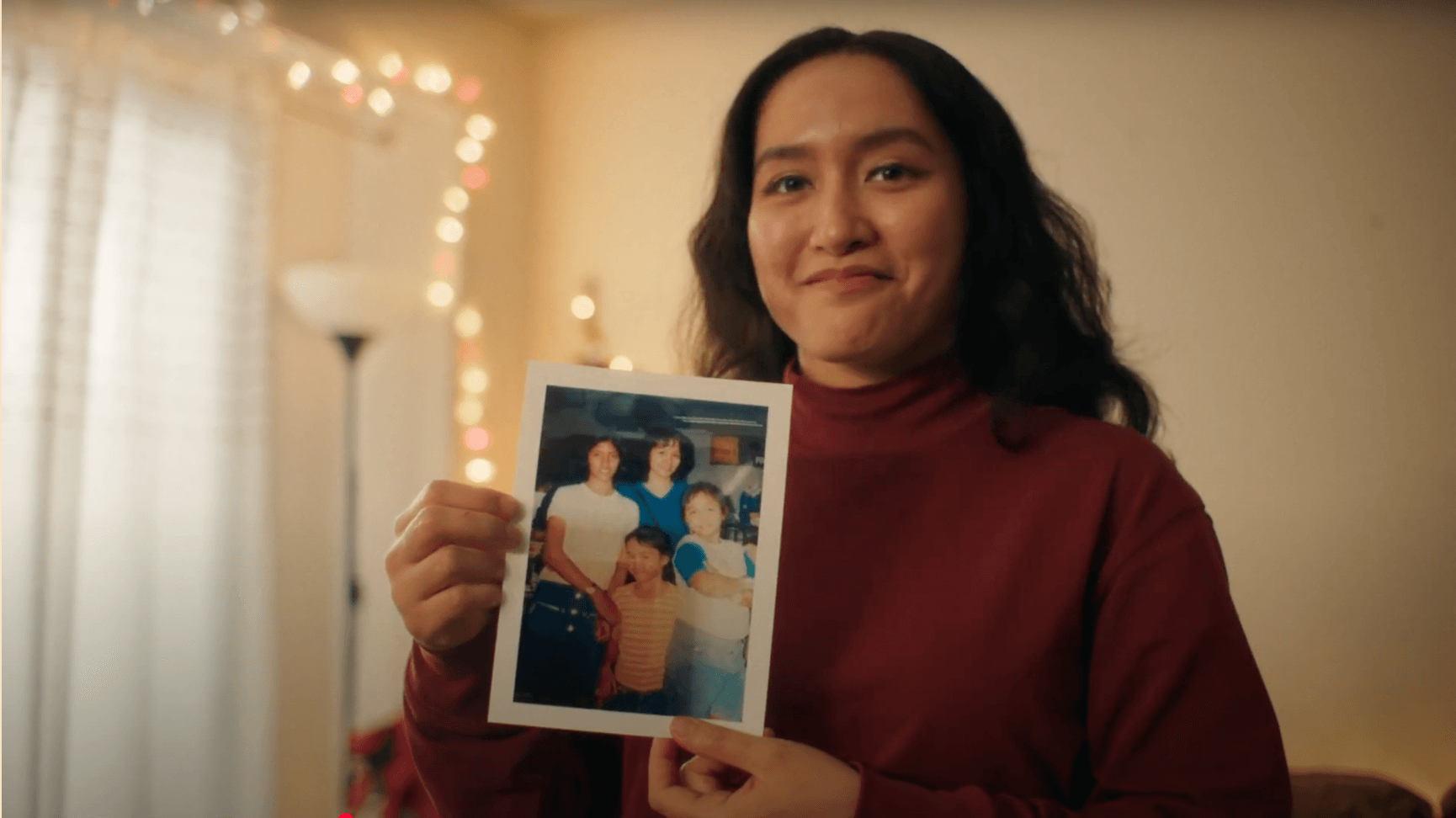 Woman holding up family photograph
