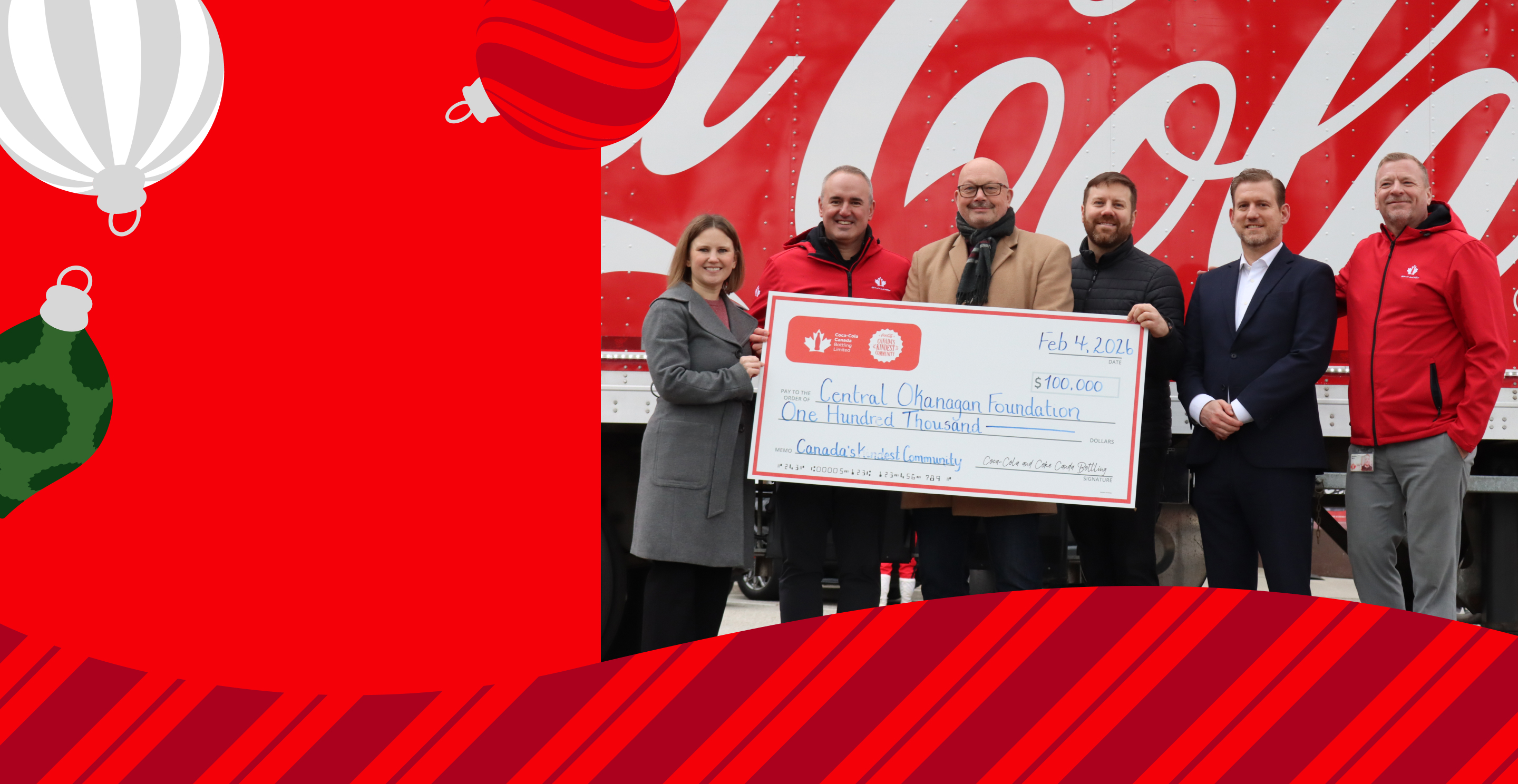 a group of people holding a check for winning the kindest community for 2025