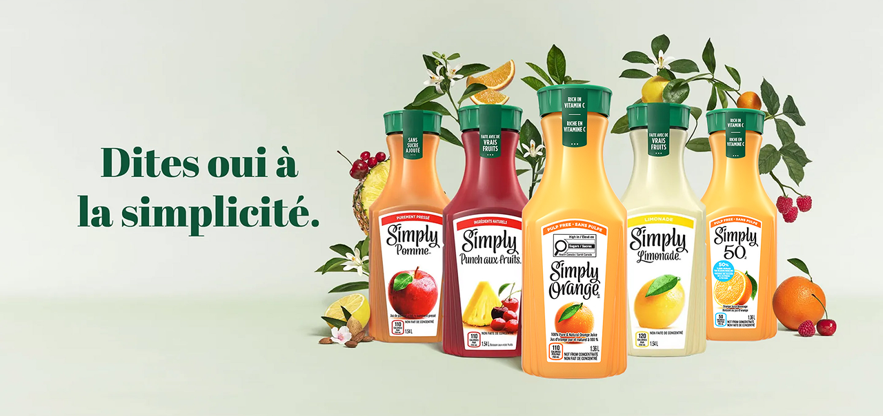 five carafes of simply drinks on a green background