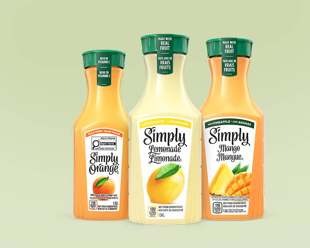 three carafes of simply drinks on a green background