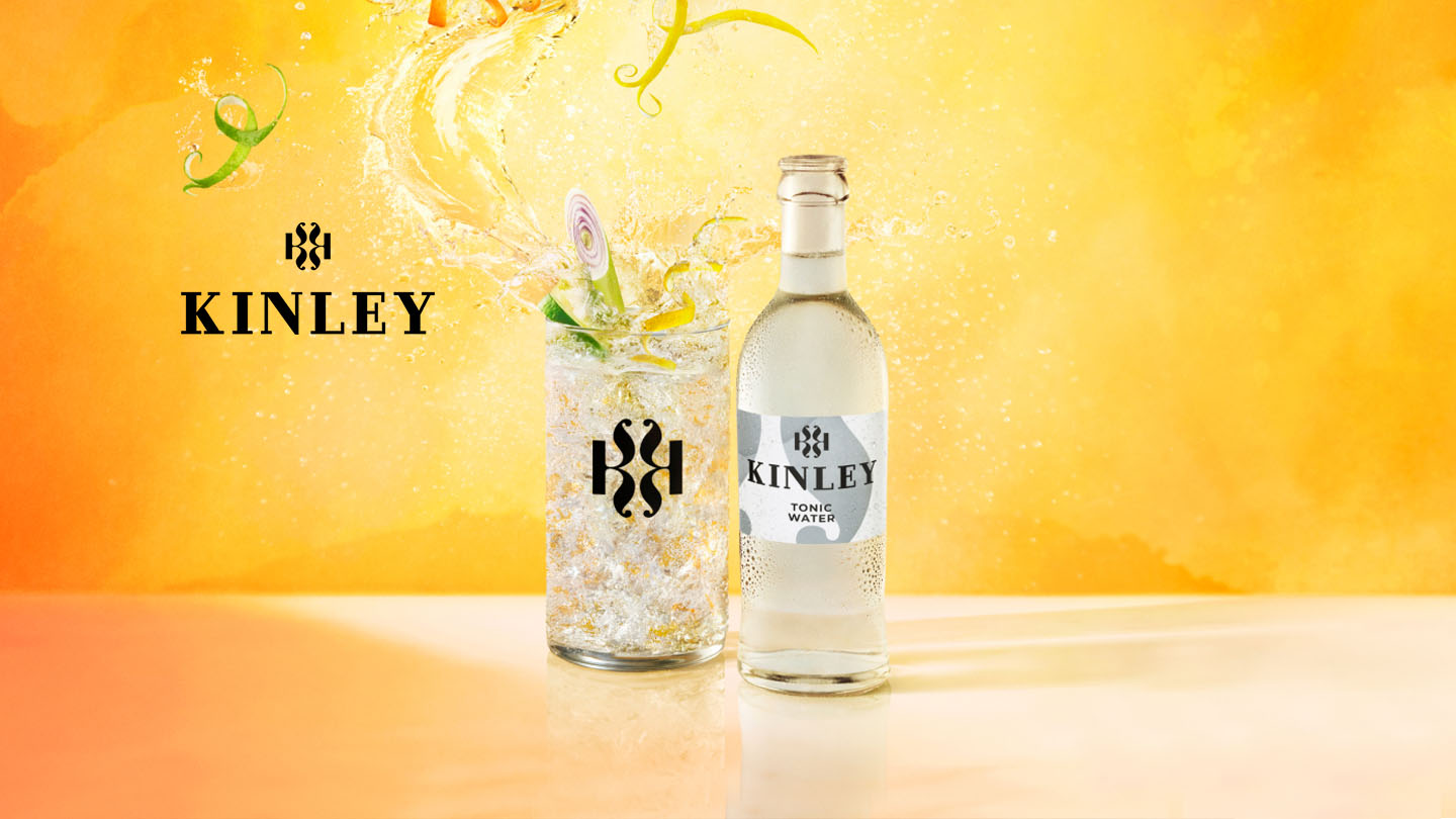 Verre avec cocktail Kinley et bouteille en verre de Kinley eau tonique