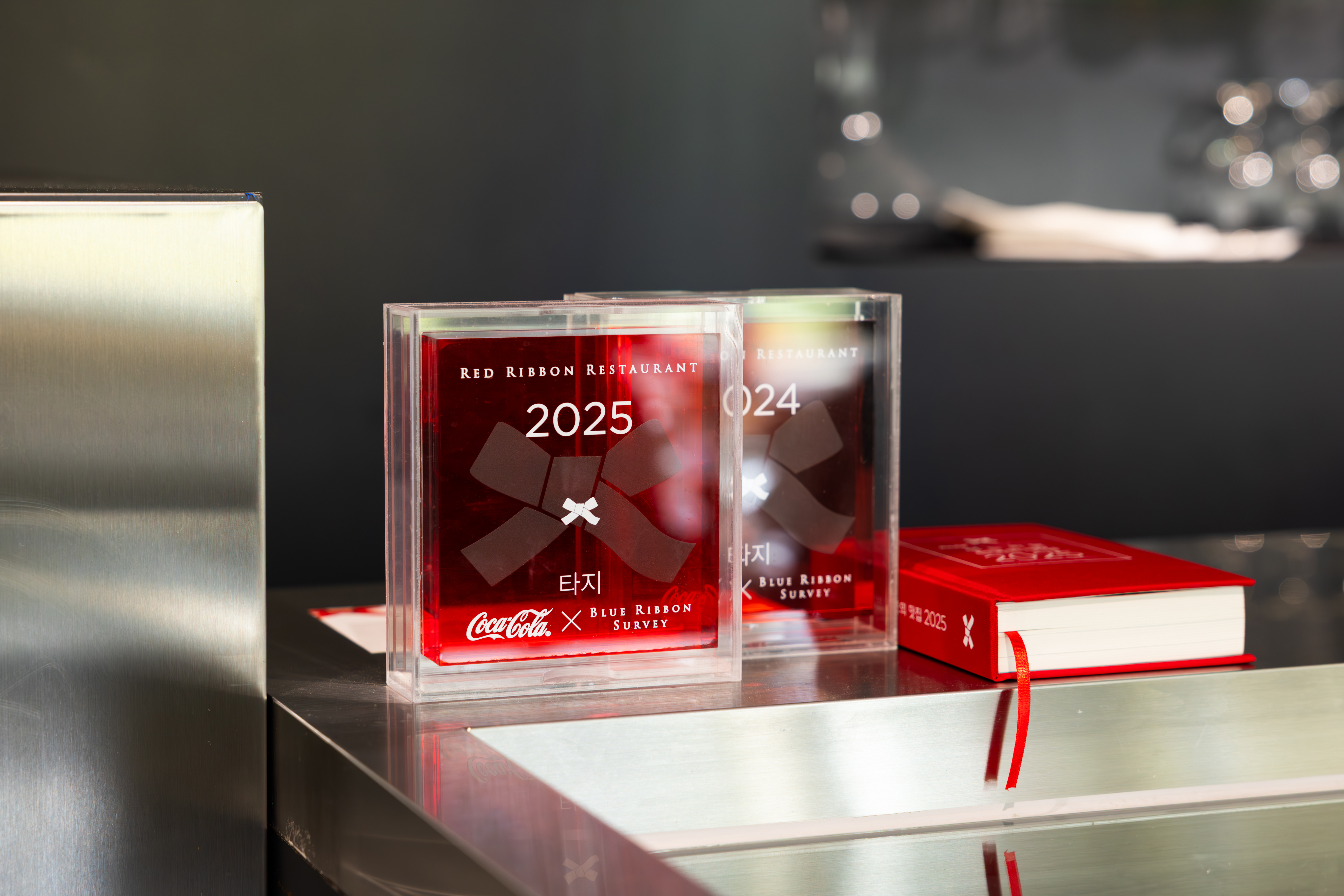 레스토랑 '타지'의 레드리본 명패와 2025 레드리본 전국의 맛집 가이드북