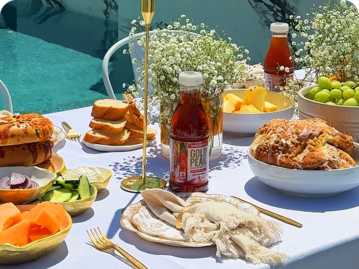 Gold peak tea drinks sitting on a table with food