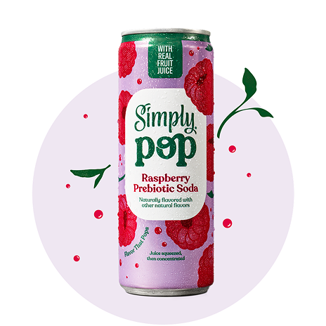 A single can of Simply Pop Raspberry Prebiotic Soda with a lavender and raspberry-print design, displayed against a soft purple circular backdrop with decorative leaf and berry accents.