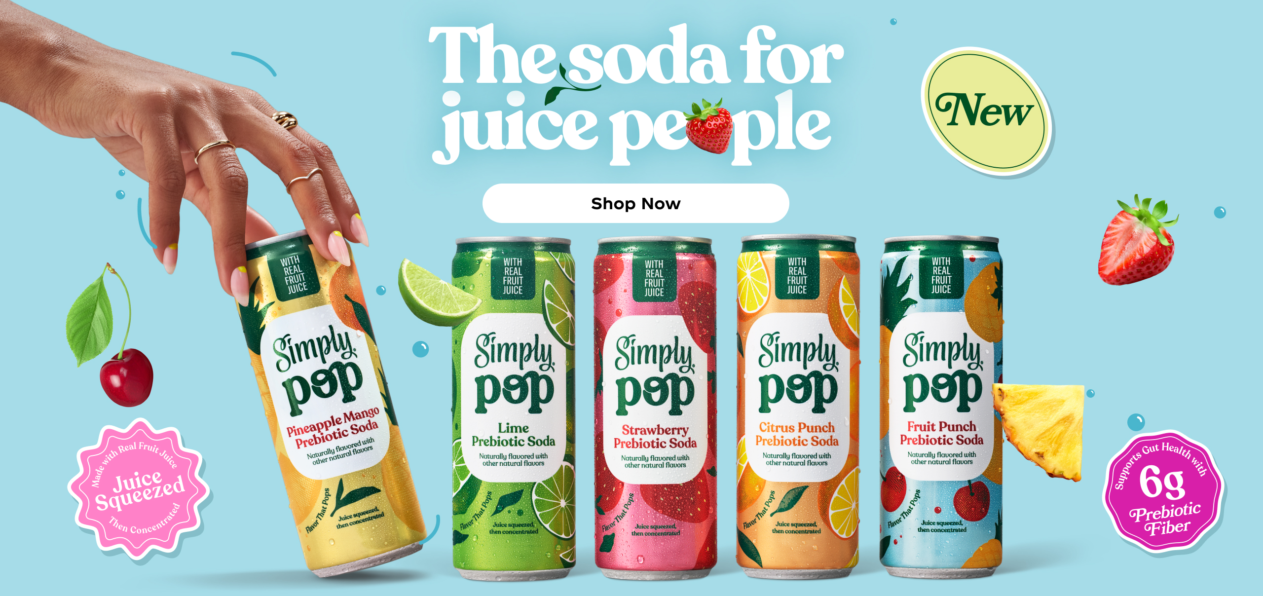A hand reaches for one of five Simply Pop prebiotic soda cans on a blue background with floating fruit and colorful badges. Text says, “The soda for juice people" with a clickable button to "Shop Now". 