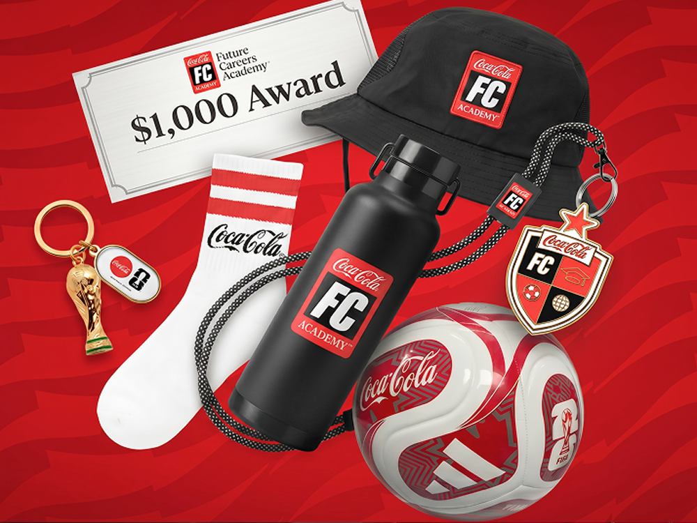 A collection of Coca-Cola FC Academy sweepstakes prizes, including a $1,000 award, soccer ball, water bottle, and hat.